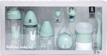 SUAVINEX Welcome Baby zestaw startowy PREMIUM z smoczkiem, klipsem, pojemnikiem na mleko i łyżeczką